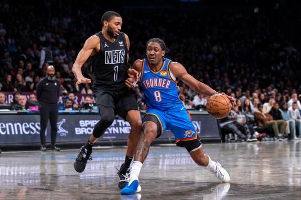 Jalen Williams #8 of the Oklahoma City Thunder drives to the basket as Mikal Bridges #1 of the Brooklyn Nets defends in the second half. 