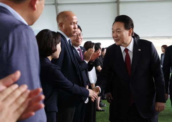 President Yoon Suk Yeol greets Democratic Party lawmaker Hong Jeong-min at the inaugural ceremony of a local event in Gyeo<em></em>nggi Province, June 30. (Yonhap)